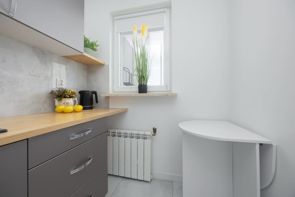 A bright kitchen corner with a countertop and window. Natural light makes the space feel fresh and airy.
