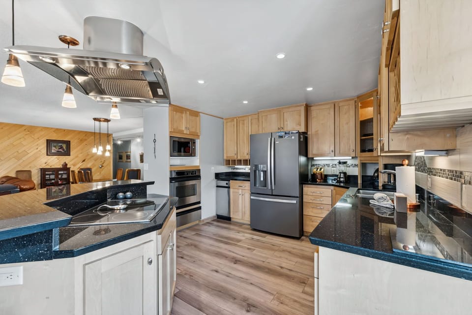 Your gourmet kitchen awaits with granite countertops, modern stainless appliances, and ample space for preparing family meals together.