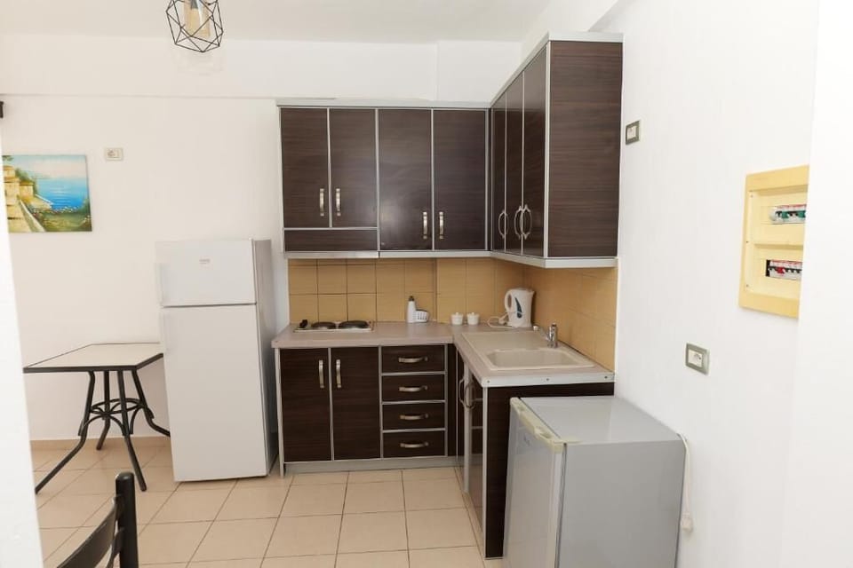 Fridge, electric kettle, dining tables