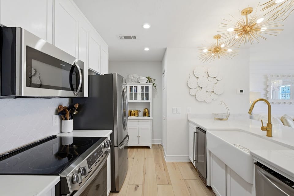 North Lost Key Landing B2- Your fully equipped kitchen features modern appliances, gleaming countertops, and elegant gold fixtures—ready for your morning coffee or a home-cooked meal.