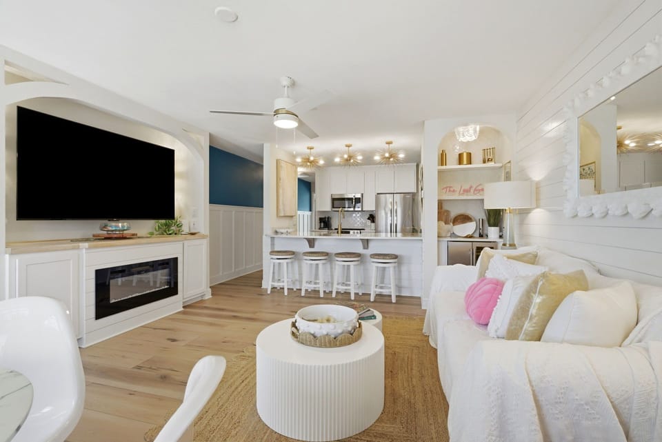 North Lost Key Landing B2- Relax in this bright, open-plan living space where coastal charm meets modern comfort. Sink into plush seating while the fireplace warms your evenings and the full kitchen invites you to create delicious meals together.
