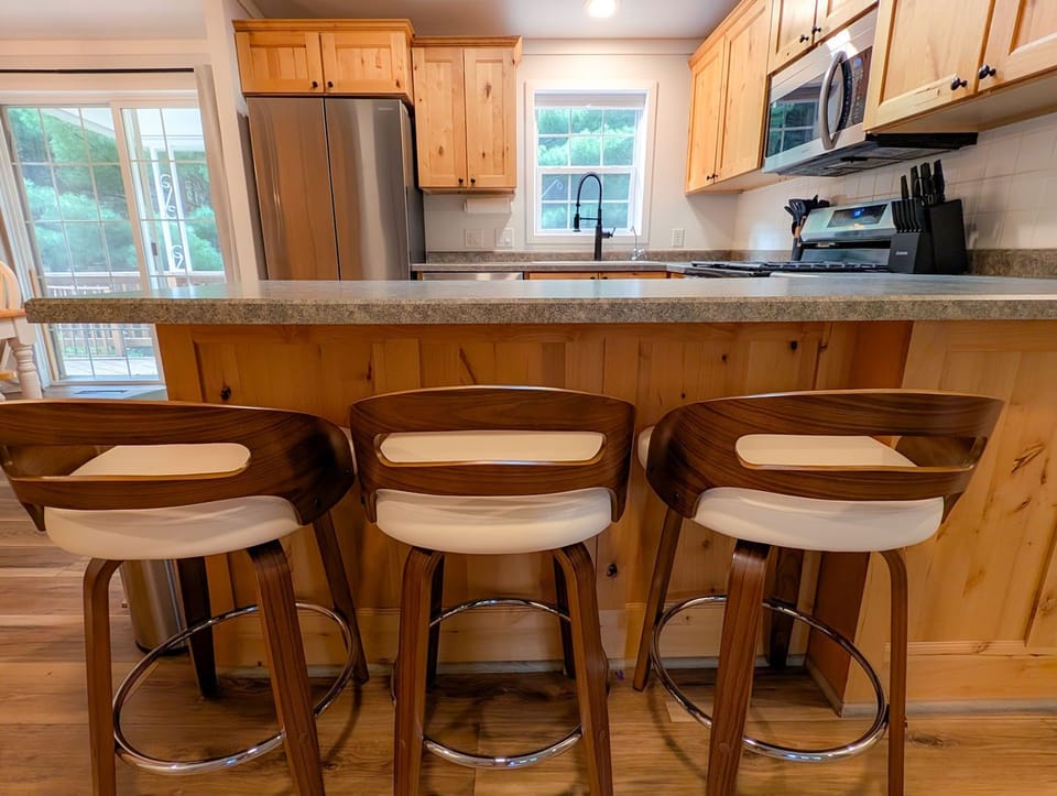 Bright rustic kitchen with breakfast bar seating for three