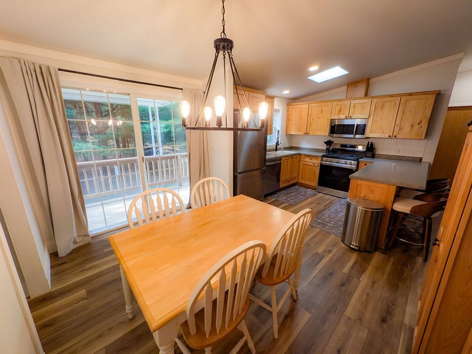 Bright dining area with full kitchen and deck access