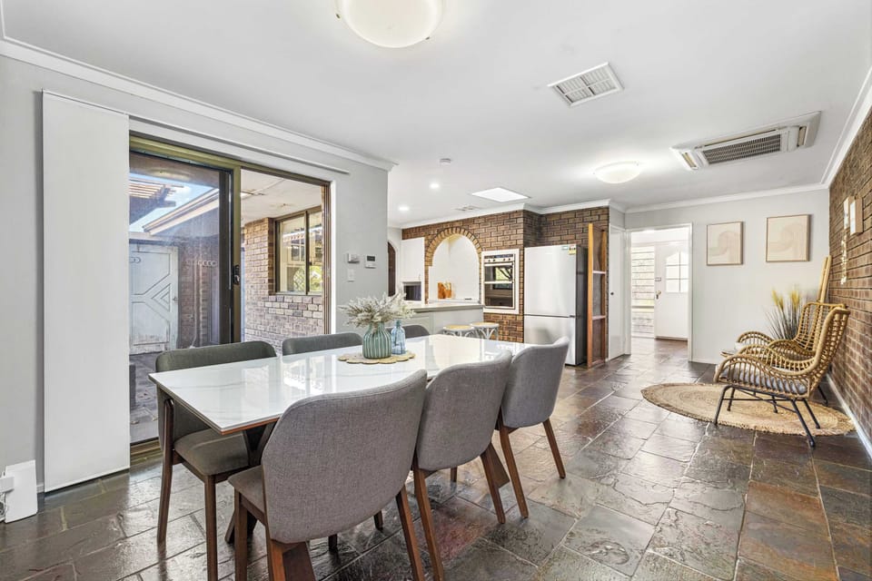 Gather, dine, and make lasting memories in our stylish dining area. Featuring a spacious table for family meals, warm brick accents, contemporary décor, and a TV for added entertainment.