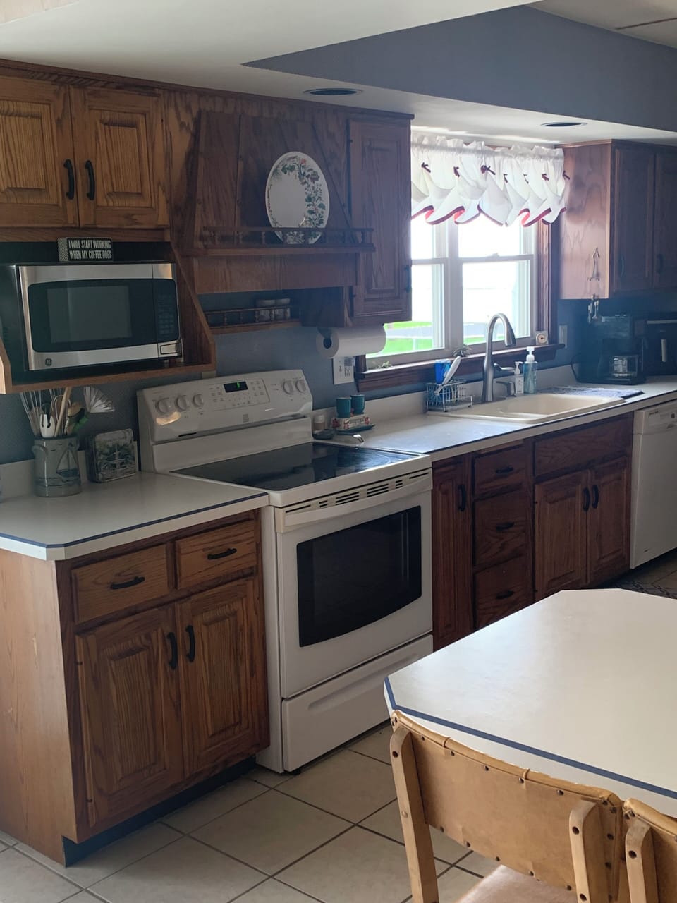 Full kitchen with electric stove, refrigerator, and dishwasher 