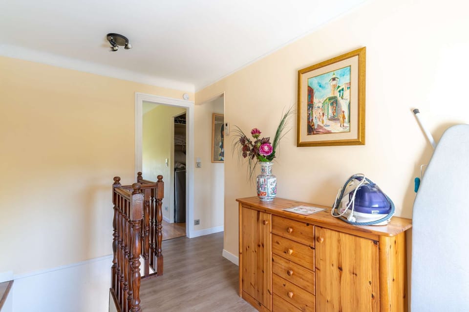 Bright staircase landing with wooden banisters
