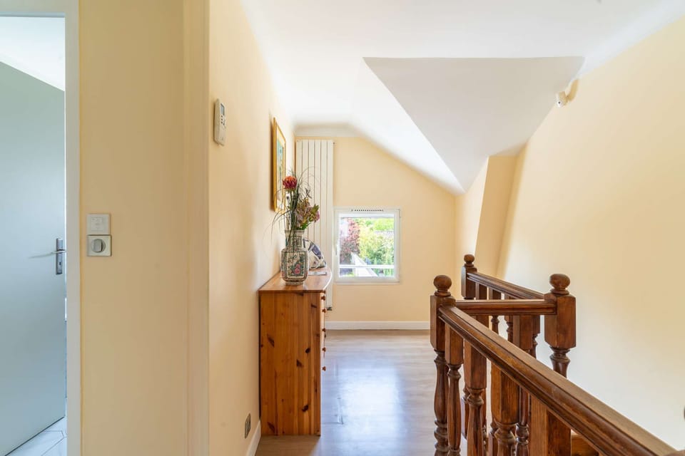 Bright staircase landing with wooden banisters