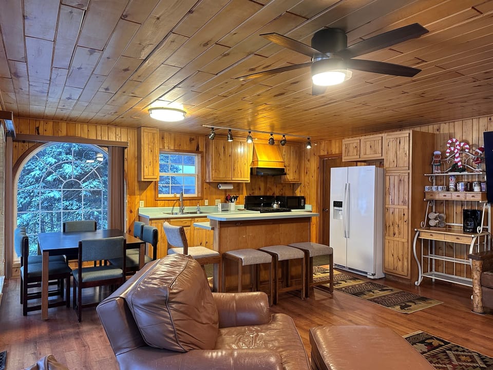 Open floor plan highlighting dining area. Table with 6 chairs as well as snack bar with 3 stools