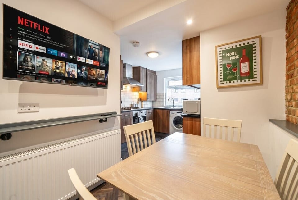 Sociable kitchen-diner with smart TV and seating for relaxed meals together