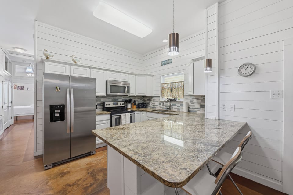 Step into your bright, modern kitchen with gleaming granite countertops, stainless steel appliances, and charming shiplap walls—the perfect space to whip up morning coffee or gather over a home-cooked meal.