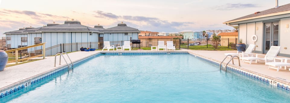 Dive into your private oasis with this sparkling pool where refreshing swims await under open skies.