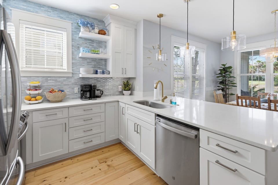 Your bright, modern kitchen awaits with gleaming countertops, stainless appliances, and a spacious island—perfect for whipping up morning coffee or preparing memorable meals during your stay.