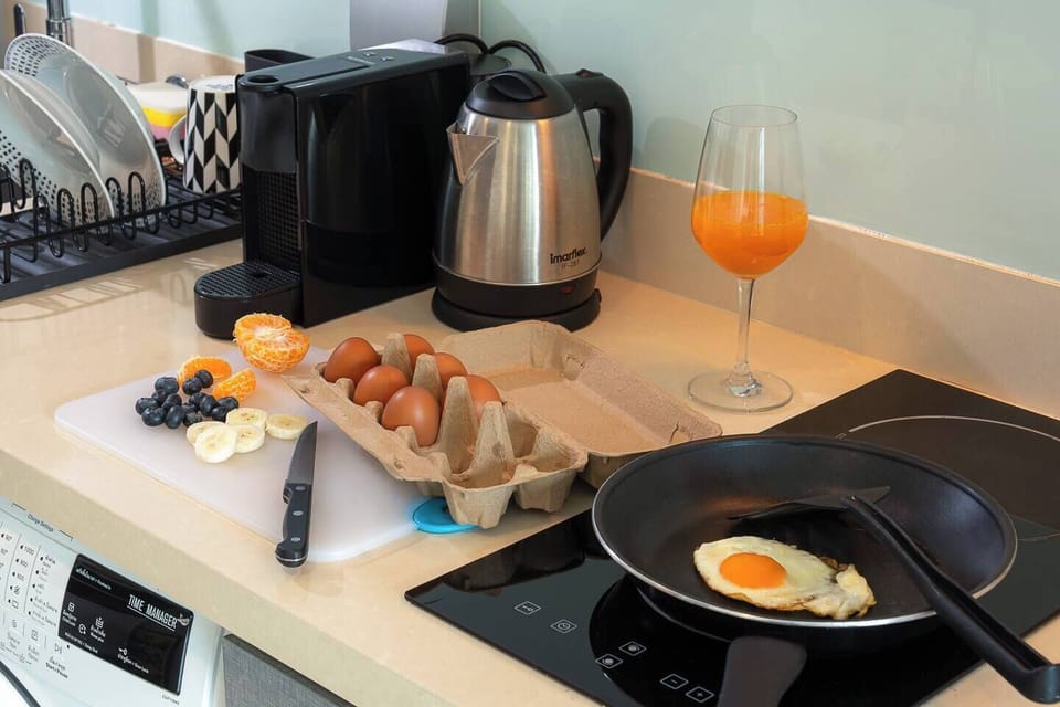 The kitchen is well-equipped and fully functional, featuring an electric stove, Nespresso machine, and a kettle with clear English labels. Also a power outlet in the kitchen with a protective cover, making it safe and convenient to use.