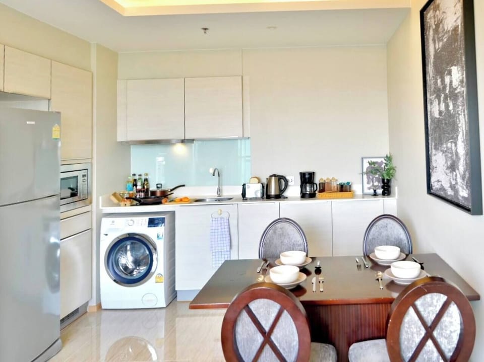 The kitchen is giving you plenty of space to cook, eat, and relax. It has a coffee corner, an electric stove, a washing machine right in the unit, and lots of cabinets to store everything you need.

