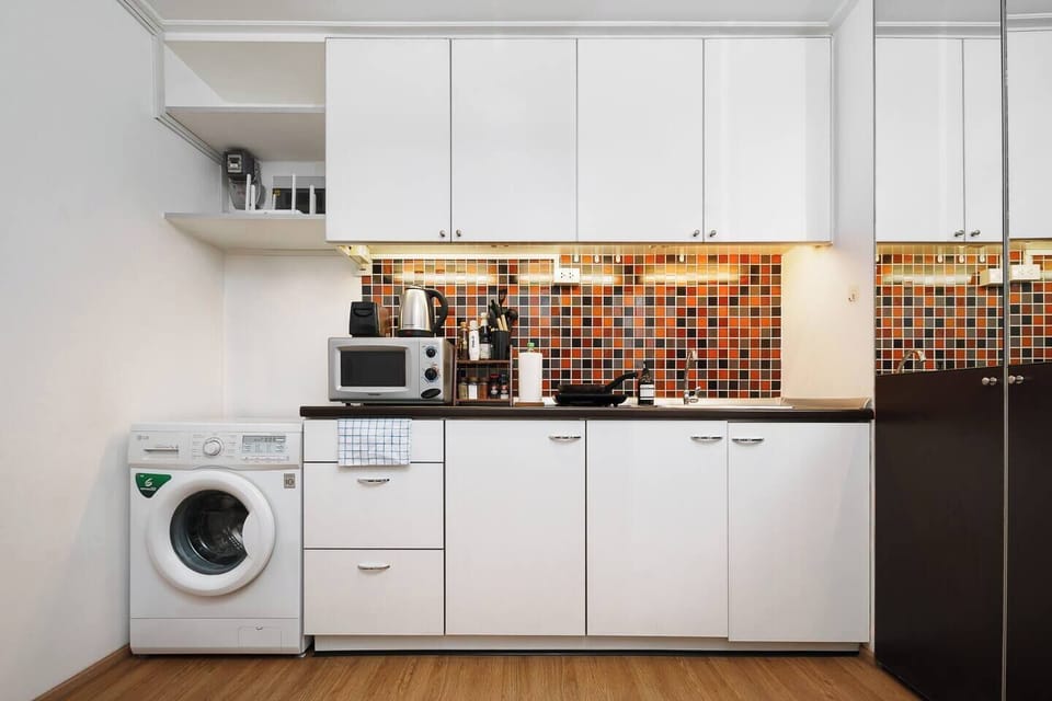 Handy Kitchen for Your Stay: Comes with stove, microwave, cookware, and basics like salt and pepper. Washing machine and cleaning supplies included for a comfortable stay.