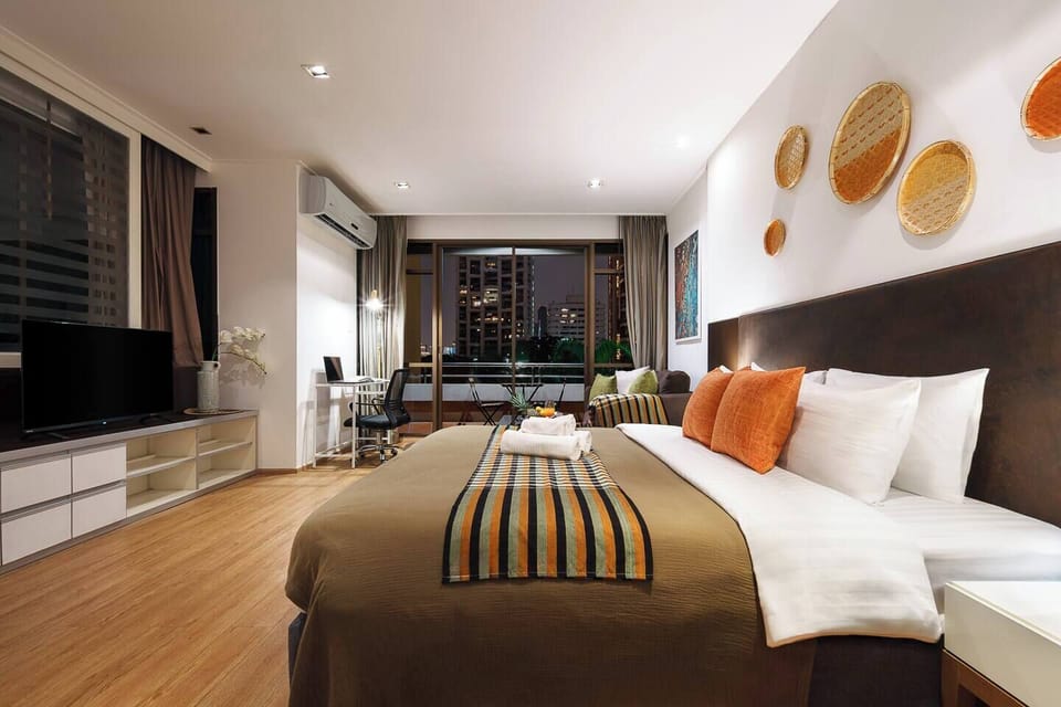 Nighttime City Ambience from Bed: Unwind with the soft glow of Bangkok’s skyline from bed or sofa. A cozy spot to watch your favorite show or read before drifting off to sleep.