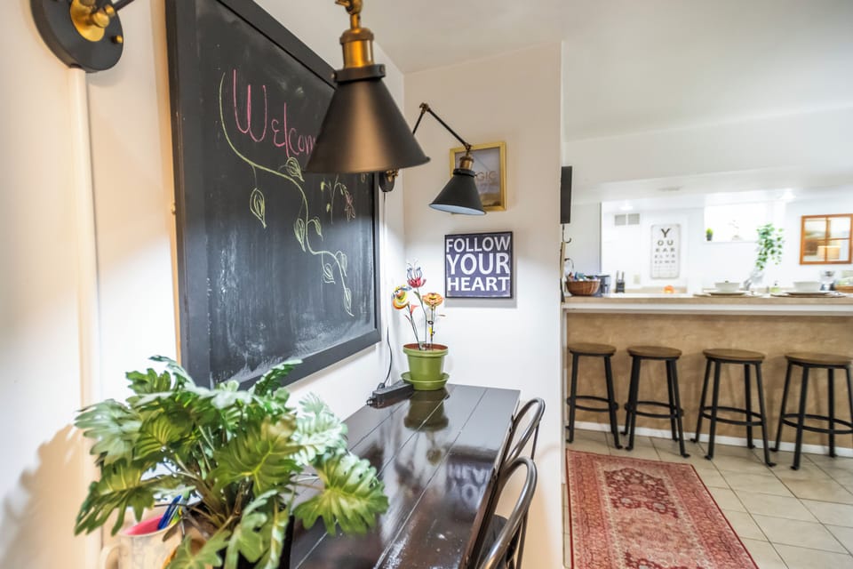 Charming dining nook with chalkboard wall and bright breakfast bar seating