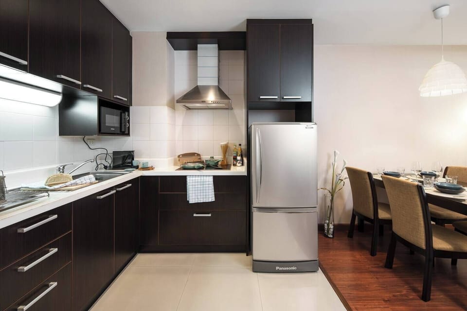 Kitchen with plenty of counter space, perfect for cooking anything from light bites to full meals. There's even a hood for your favorite stir-fry dishes.