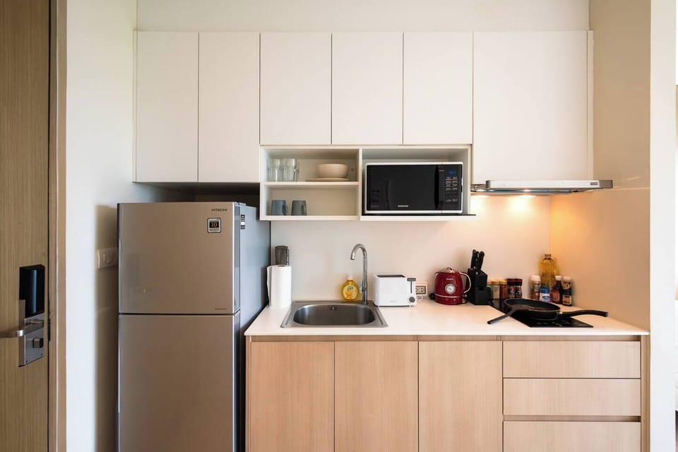 Fully equipped kitchen with big fridge, electric stove, microwave which is fit for light and heavy cooking.