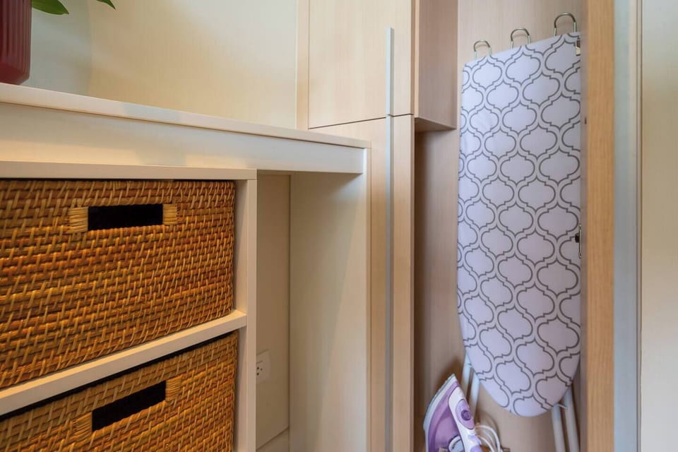 ironing board and iron is located in the dining area closet .