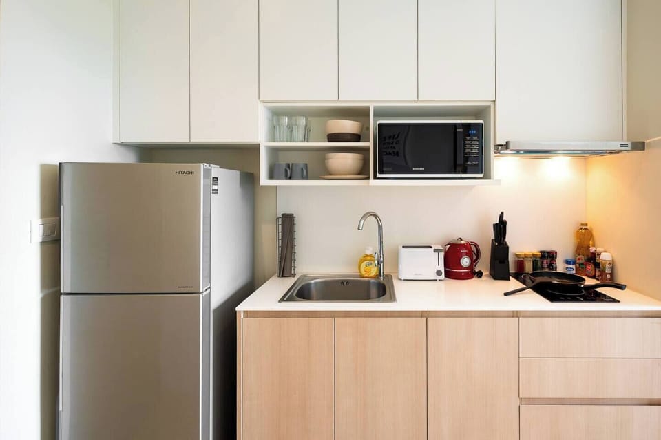 toaster, kettle, selections of cooking utensils, plate, wine glasses and basic cooking sauces are stored.