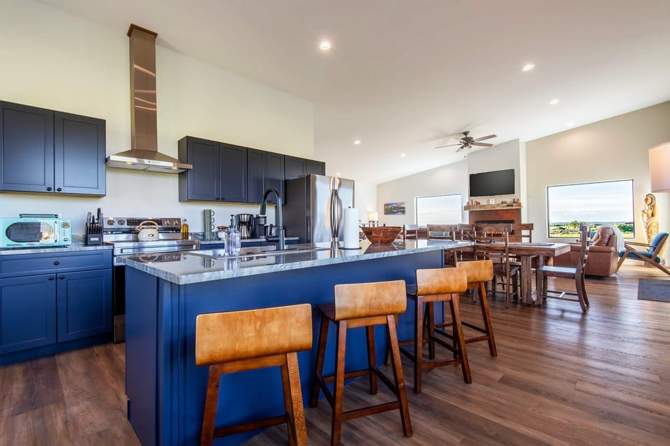 The kitchen island is blue and generous, with plenty of seating.