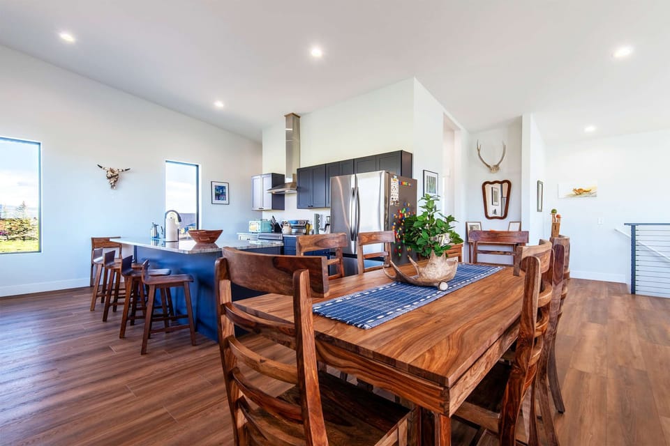 Eight chairs surround the dining table, ready for meals and long conversations.