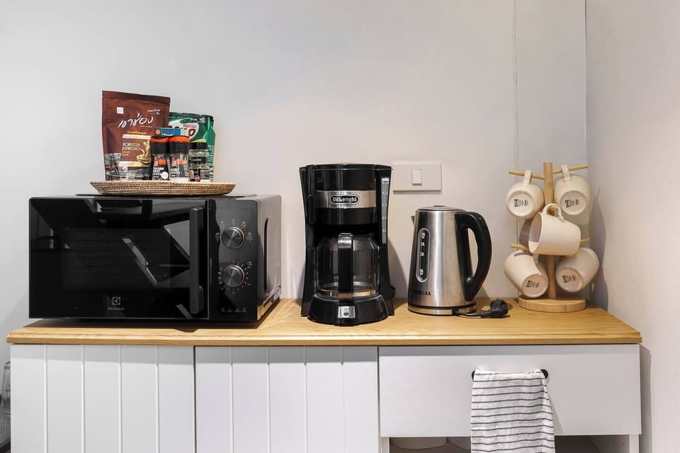 【 Dining area , Ground Floor 】We’ve prepared everything you may need during your stay. The microwave, coffee machine, and other appliances are labeled in English for easy use .
