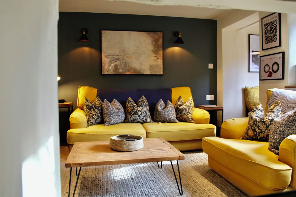 Cozy modern lounge with bold yellow seating and warm designer touches