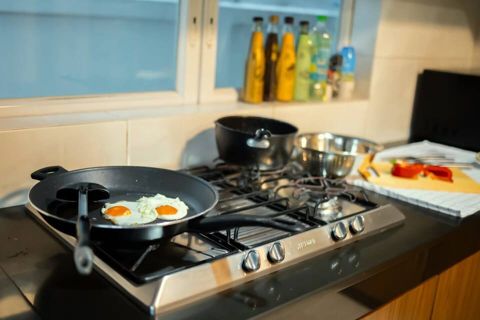 【 Kitchen area 】Preparing light or heavy meals with a gas stove, common seasonings (soy sauce, oil, chili), and grocery stores (K-Village, Big C, 7/11) a short walk away. 