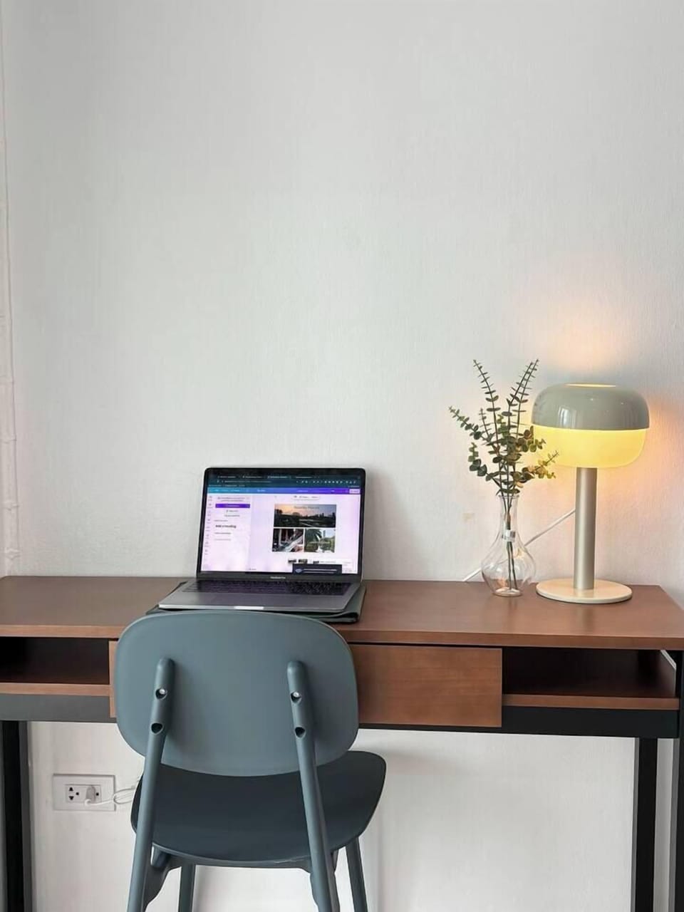A large desk is provided for working, and there's a convenient power outlet nearby for your devices.