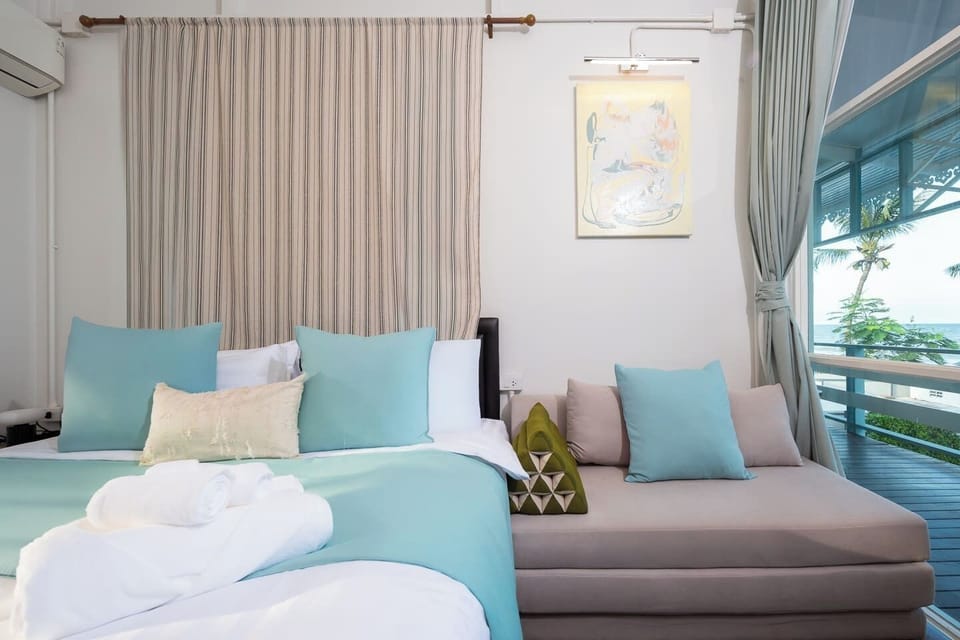 Serene coastal bedroom with ocean-view balcony and plush comforts