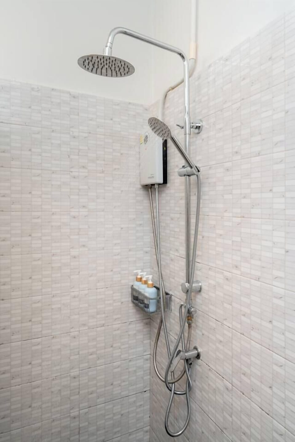 Modern rain shower with hot water and toiletries provided