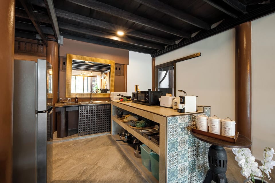 Charming kitchenette with traditional beams, tile accents, and modern amenities