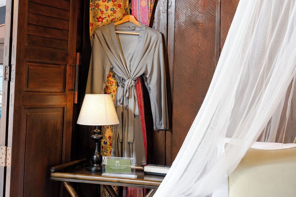 Cozy bedroom details with robe, warm wood accents, and romantic canopy