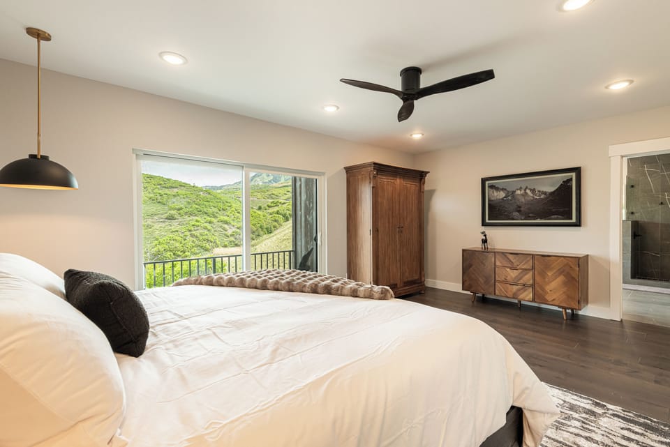 Primary bedroom with a smart TV and a view
