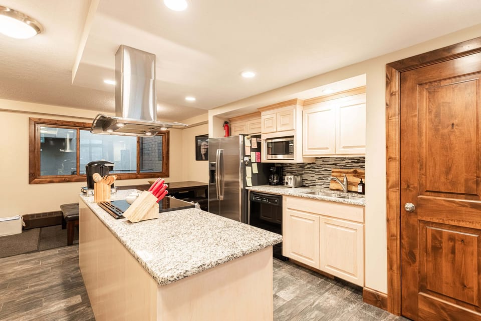 The fully equipped kitchen features a gas and electric range with four burners, single oven, microwave, and both a Drip coffee maker and Keurig coffee options for an easy start to every day.