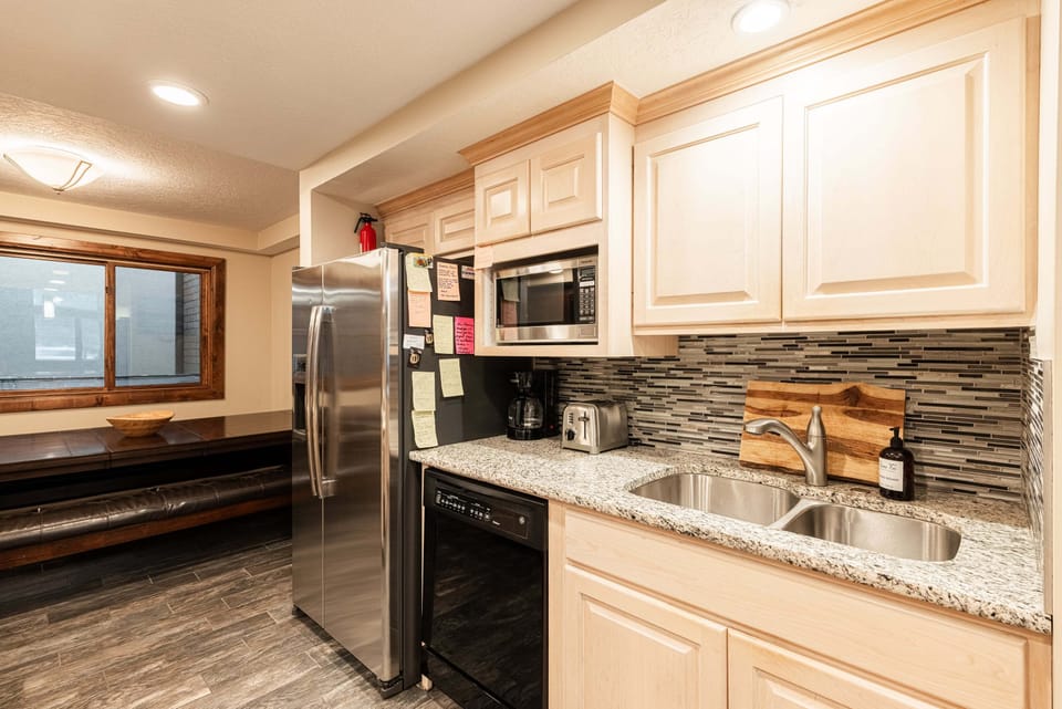 The fully equipped kitchen features a gas and electric range with four burners, single oven, microwave, and both a Drip coffee maker and Keurig coffee options for an easy start to every day.