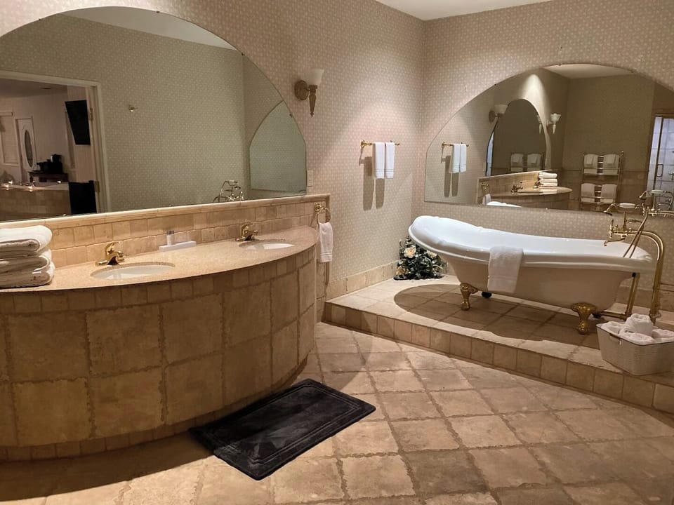 Refresh in a spacious bath with elegant tub and vanity.