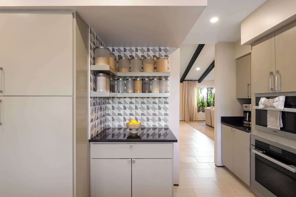 Modern chef’s kitchen featuring premium appliances, sleek cabinetry, and a bright dining nook, offering a stylish space to prepare and enjoy your favorite meals.