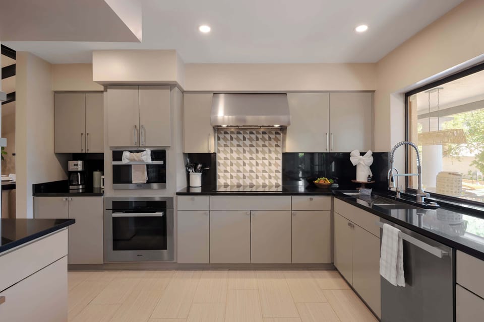 Modern chef’s kitchen featuring premium appliances, sleek cabinetry, and a bright dining nook, offering a stylish space to prepare and enjoy your favorite meals.
