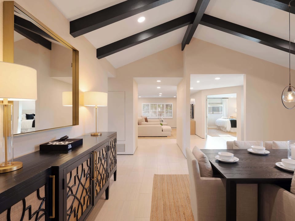 Elegant formal dining room with seating for eight, soaring vaulted ceilings, and statement lighting, creating a refined setting for memorable dinners.