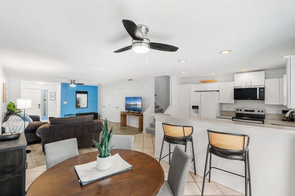 Gather around the dining table for meals with friends and family, and the breakfast bar seats two