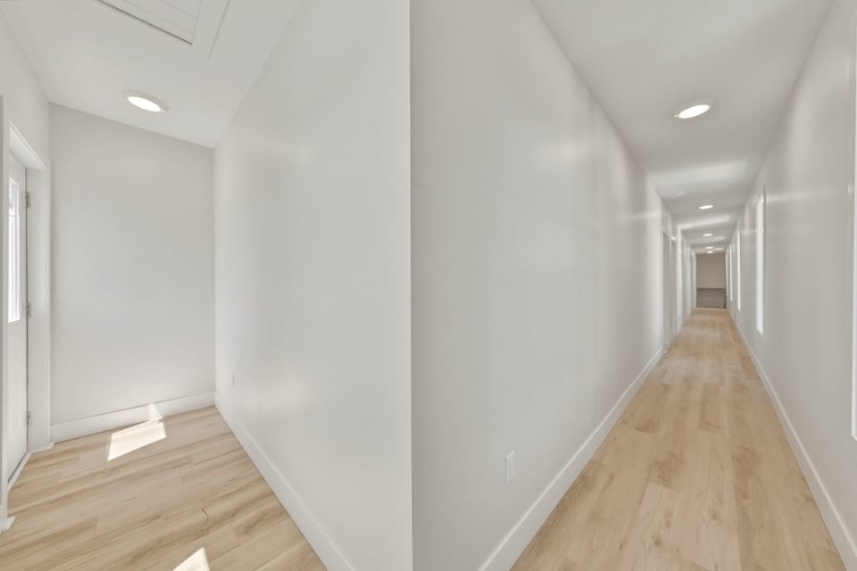 Bright, spacious hallway with modern finishes and easy access to multiple rooms.