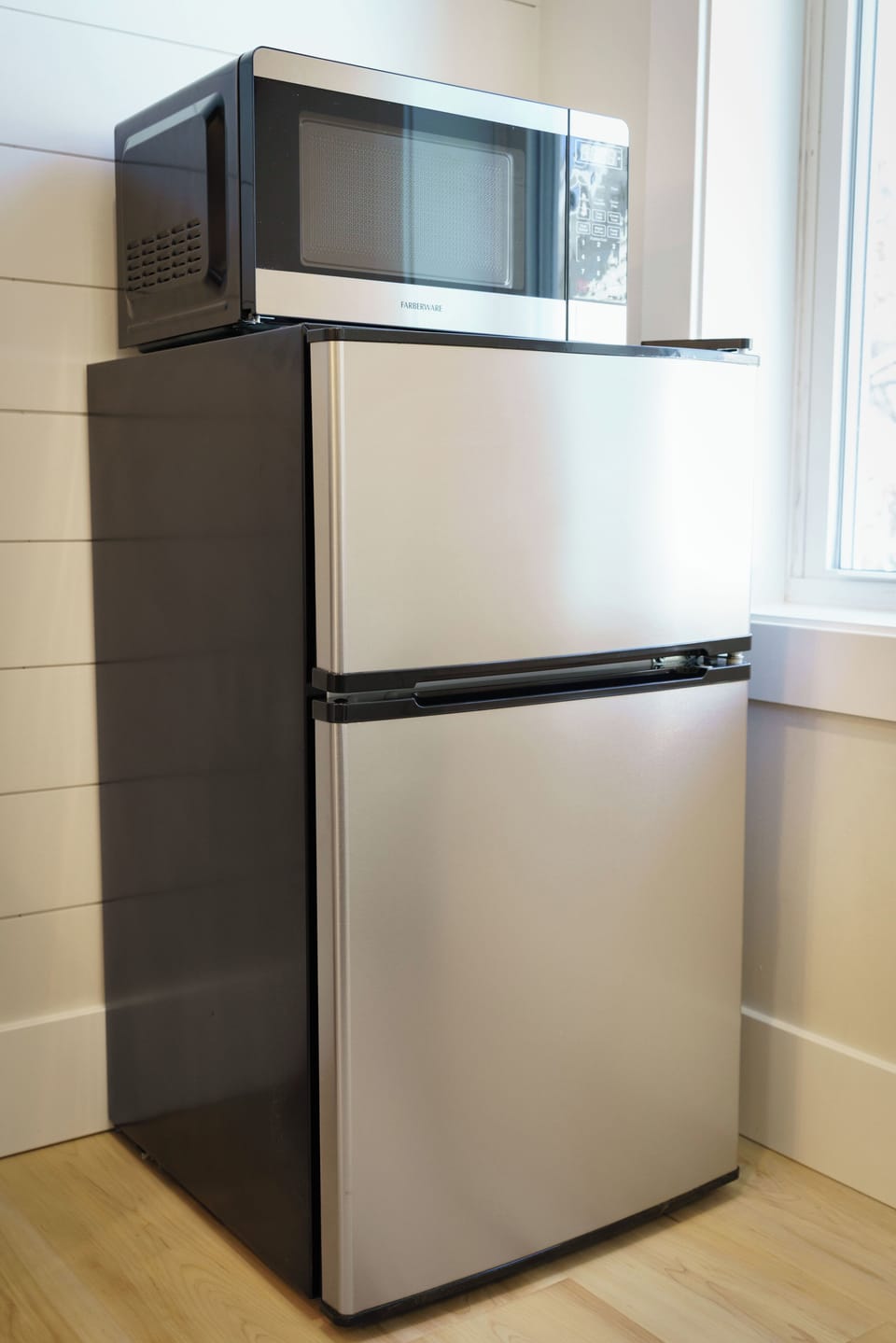 Keep your favorite drinks perfectly chilled and snacks ready to go. This convenient in-suite refreshment corner features a sleek, stainless steel two-door mini-fridge with a separate freezer compartment, topped with a digital microwave for late-night cravings or effortless morning bites.