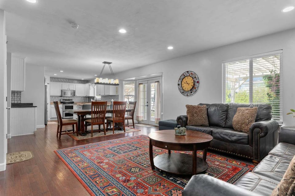 Open-plan dining and living area with French doors leading to the deck