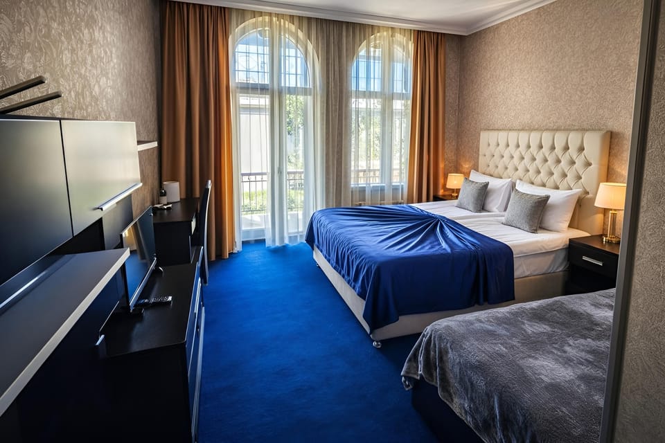 Deluxe Triple Room, Balcony | In-room safe, desk, soundproofing, iron/ironing board