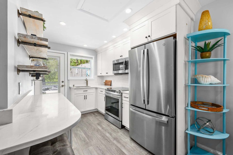 Fully equipped kitchen featuring modern appliances and all the essentials needed for preparing meals and enjoying home-cooked dining during your stay.