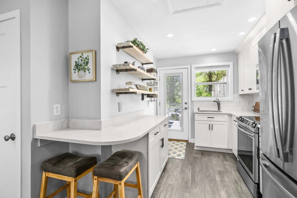 The kitchen offers countertop seating, providing a casual and convenient spot for meals, morning coffee, or gathering while meals are being prepared.