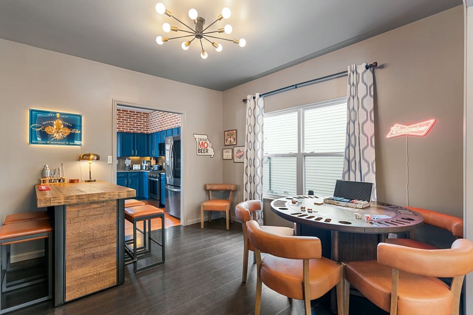 Gather for drinks, cards, and conversation in Brewmasters Hall, featuring a rustic wood bar with bartending setup, glassware, cards, and games.